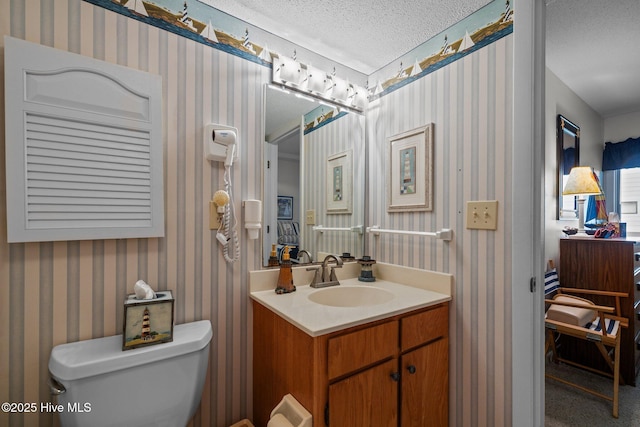 10300 Coast Guard Rd Unit E206Point, Emerald Villas, Emerald Isle, NC 28594 - half bath featuring vanity, a textured ceiling, and wallpapered walls