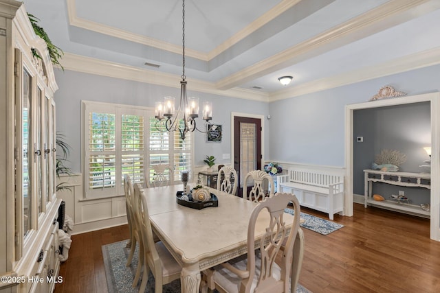 9134 Ocean Harbour Golf Club Rd SW, Calabash, NC 28467 - dining space featuring a chandelier, dark wood-type flooring, a raised ceiling, a decorative wall, and a wainscoted wall