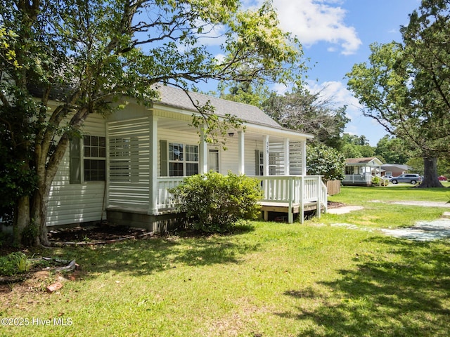 579 Hubert Blvd, Hubert, NC 28539 - view of home's exterior featuring a yard, covered porch, and roof with shingles