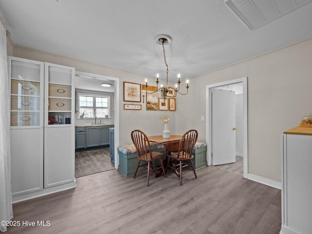 579 Hubert Blvd, Hubert, NC 28539 - dining room featuring light wood-style flooring and a chandelier