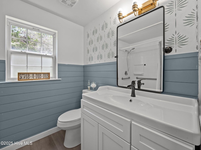 579 Hubert Blvd, Hubert, NC 28539 - bathroom featuring a shower, vanity, a wainscoted wall, and wood finished floors