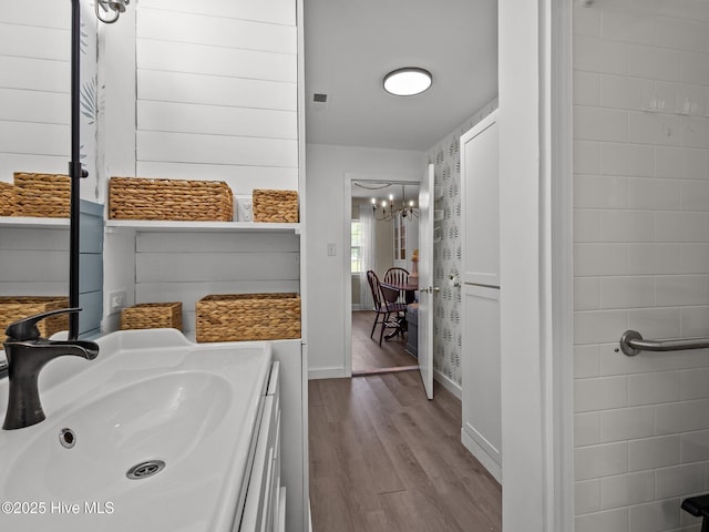579 Hubert Blvd, Hubert, NC 28539 - bathroom featuring wood finished floors and a chandelier
