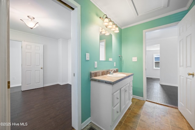 907 Woodruff Ave, Elizabeth City, NC 27909 - bathroom with vanity, crown molding, and wood finished floors