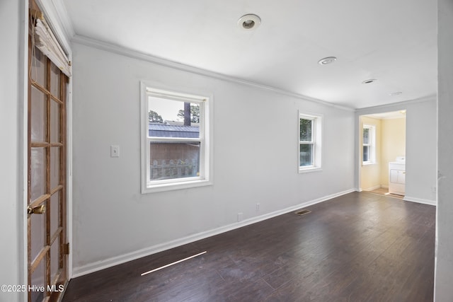 907 Woodruff Ave, Elizabeth City, NC 27909 - unfurnished room with crown molding, washer / clothes dryer, healthy amount of natural light, and wood finished floors
