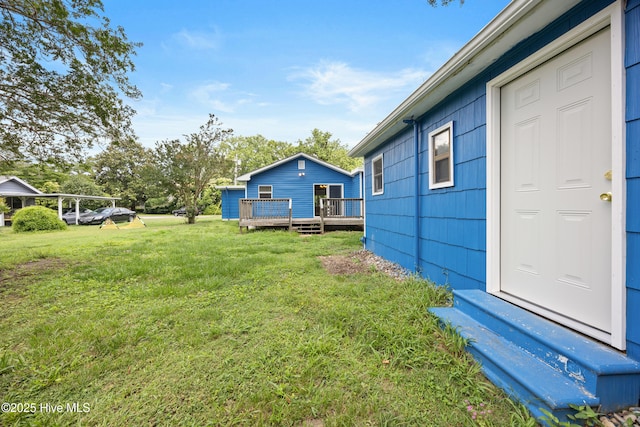 907 Woodruff Ave, Elizabeth City, NC 27909 - view of grassy yard featuring a wooden deck and entry steps