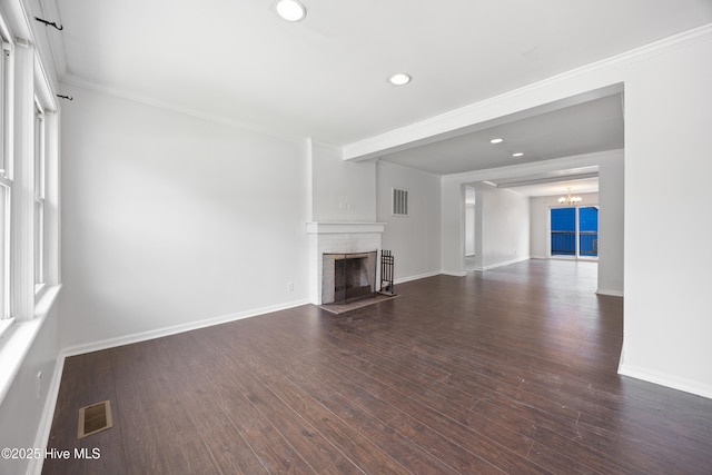 907 Woodruff Ave, Elizabeth City, NC 27909 - unfurnished living room with ornamental molding, a brick fireplace, recessed lighting, wood finished floors, and a chandelier