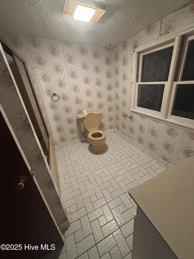 2440 Ocean Sound Cir SW, Supply, NC 28462 - bathroom featuring wallpapered walls, brick patterned flooring, and a textured ceiling