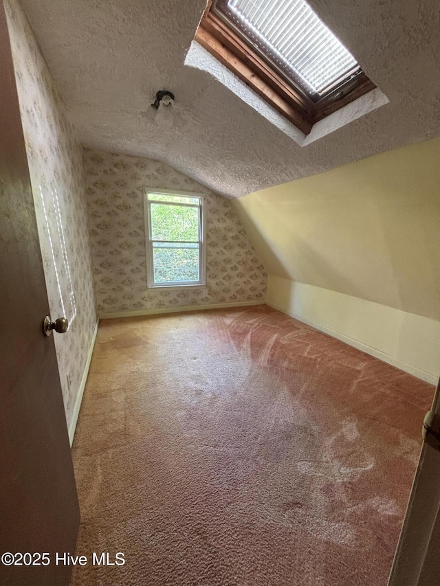 2440 Ocean Sound Cir SW, Supply, NC 28462 - additional living space featuring a textured ceiling, carpet, lofted ceiling, and wallpapered walls