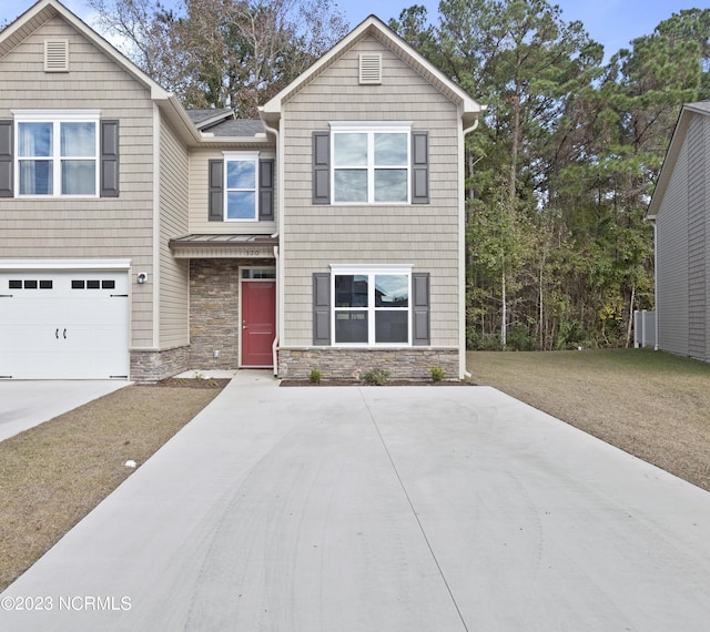 463 Sullivan Loop Rd, Midway Park, NC 28544 - view of front of home featuring stone siding, driveway, an attached garage, and a front lawn