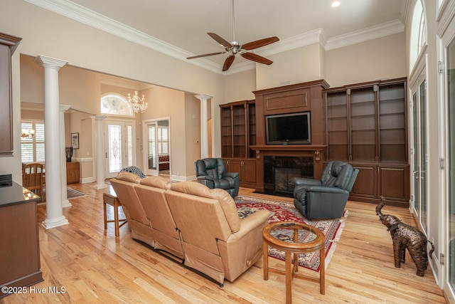 545 Gladstone Cir SW, Ocean Isle Beach, NC 28469 - living area featuring decorative columns, a fireplace, light wood-style flooring, crown molding, and ceiling fan