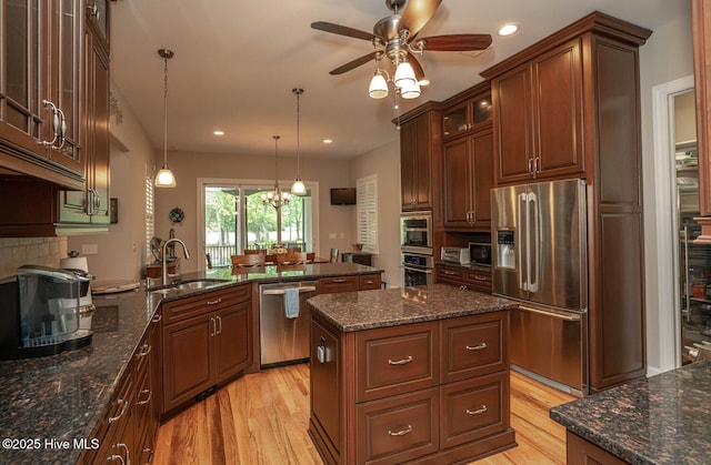 545 Gladstone Cir SW, Ocean Isle Beach, NC 28469 - kitchen featuring stainless steel appliances, light wood finished floors, a ceiling fan, glass insert cabinets, and recessed lighting