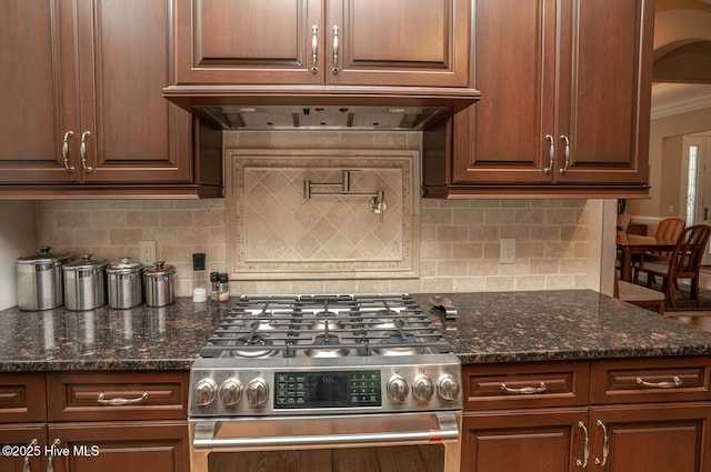 545 Gladstone Cir SW, Ocean Isle Beach, NC 28469 - kitchen with stainless steel gas range, range hood, tasteful backsplash, ornamental molding, and dark stone counters