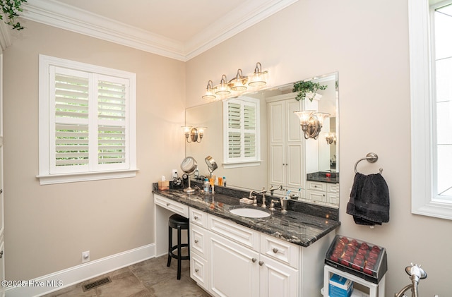 545 Gladstone Cir SW, Ocean Isle Beach, NC 28469 - bathroom featuring ornamental molding, vanity, and plenty of natural light