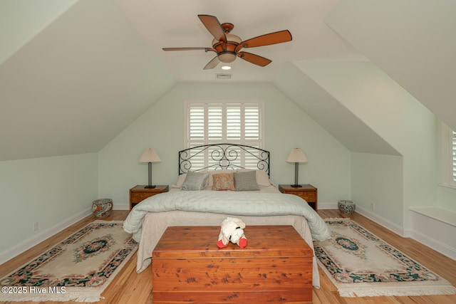 545 Gladstone Cir SW, Ocean Isle Beach, NC 28469 - bedroom with wood finished floors, ceiling fan, and vaulted ceiling