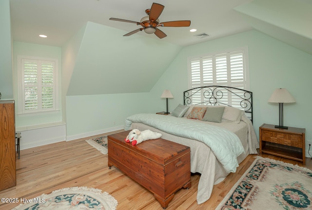 545 Gladstone Cir SW, Ocean Isle Beach, NC 28469 - bedroom with multiple windows, wood finished floors, vaulted ceiling, a ceiling fan, and recessed lighting