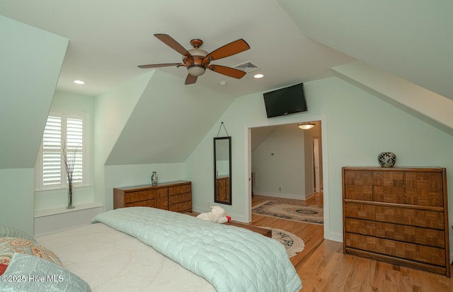 545 Gladstone Cir SW, Ocean Isle Beach, NC 28469 - bedroom with wood finished floors, lofted ceiling, recessed lighting, and a ceiling fan