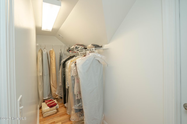 545 Gladstone Cir SW, Ocean Isle Beach, NC 28469 - spacious closet featuring lofted ceiling and wood finished floors