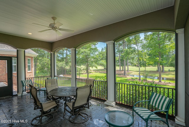545 Gladstone Cir SW, Ocean Isle Beach, NC 28469 - sunroom / solarium featuring a ceiling fan, a water view, outdoor dining space, and view of scattered trees