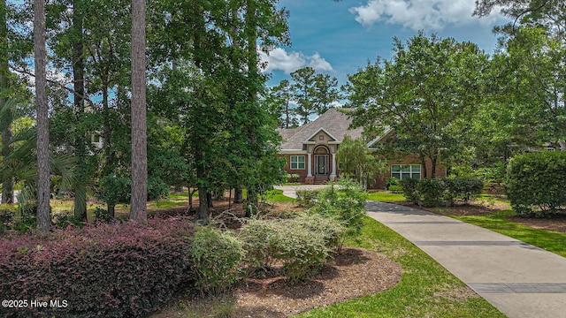 545 Gladstone Cir SW, Ocean Isle Beach, NC 28469 - view of property hidden behind natural elements with roof with shingles