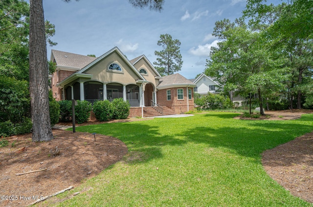 545 Gladstone Cir SW, Ocean Isle Beach, NC 28469 - view of front of home featuring brick siding, a front yard, and covered porch