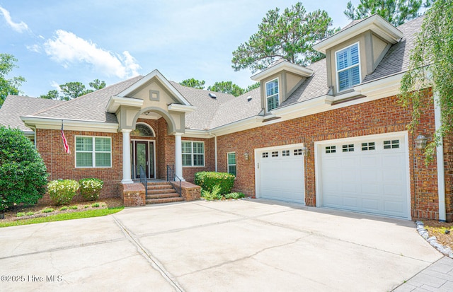 545 Gladstone Cir SW, Ocean Isle Beach, NC 28469 - traditional home featuring concrete driveway, brick siding, a shingled roof, and a garage