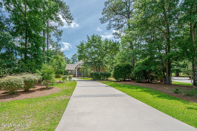 545 Gladstone Cir SW, Ocean Isle Beach, NC 28469 - obstructed view of property with a front lawn