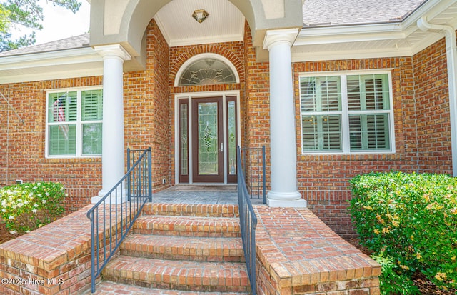 545 Gladstone Cir SW, Ocean Isle Beach, NC 28469 - property entrance featuring brick siding and covered porch
