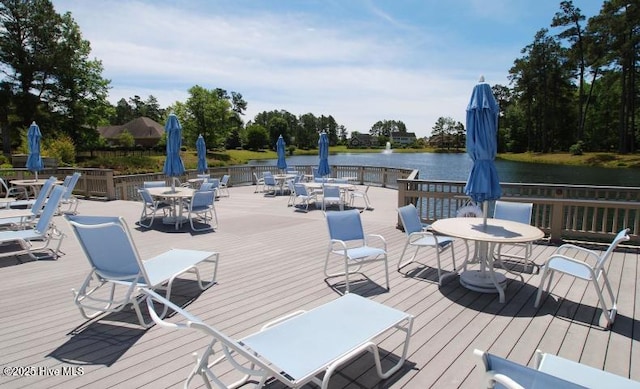 545 Gladstone Cir SW, Ocean Isle Beach, NC 28469 - wooden deck featuring outdoor dining area and a water view