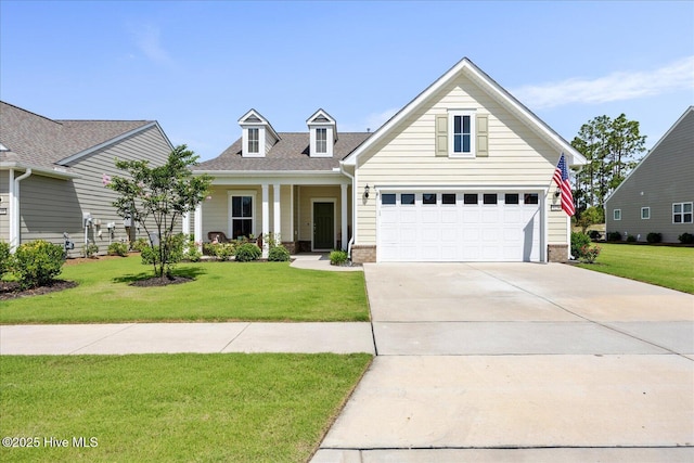 3236 Penzance Row, Wilmington, NC 28412 - view of front of house featuring driveway, a front yard, an attached garage, and brick siding