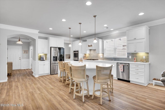 3236 Penzance Row, Wilmington, NC 28412 - kitchen with appliances with stainless steel finishes, ornamental molding, light countertops, arched walkways, and recessed lighting