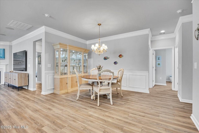 3236 Penzance Row, Wilmington, NC 28412 - dining area with light wood finished floors, ornamental molding, a chandelier, wainscoting, and recessed lighting