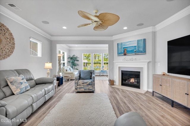 3236 Penzance Row, Wilmington, NC 28412 - living room with light wood-type flooring, a ceiling fan, crown molding, a fireplace with flush hearth, and recessed lighting