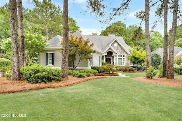 220 October Glory Dr, Wallace, NC 28466 - view of front of home with a front yard, a chimney, and stone siding