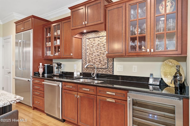 220 October Glory Dr, Wallace, NC 28466 - kitchen featuring stainless steel appliances, wine cooler, crown molding, dark stone countertops, and brown cabinets