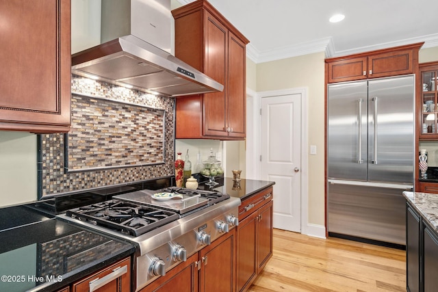220 October Glory Dr, Wallace, NC 28466 - kitchen featuring appliances with stainless steel finishes, extractor fan, ornamental molding, light wood-style flooring, and decorative backsplash