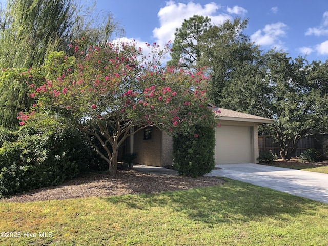 7417 Coker Ct, Wilmington, NC 28411 - view of property hidden behind natural elements featuring concrete driveway and an attached garage