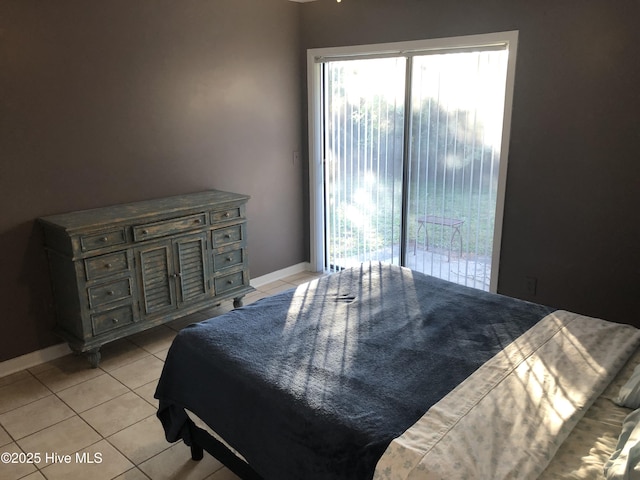 7417 Coker Ct, Wilmington, NC 28411 - bedroom featuring multiple windows, light tile patterned floors, and access to outside