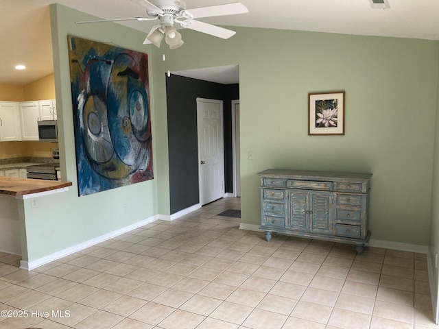 7417 Coker Ct, Wilmington, NC 28411 - kitchen featuring wood counters, light tile patterned floors, ceiling fan, stainless steel appliances, and white cabinetry