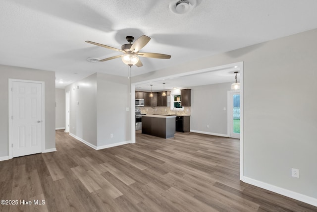 411 Cardinal Dr, Jacksonville, NC 28546 - unfurnished living room featuring a ceiling fan and wood finished floors