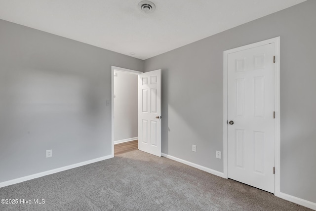 411 Cardinal Dr, Jacksonville, NC 28546 - unfurnished bedroom with carpet floors and baseboards