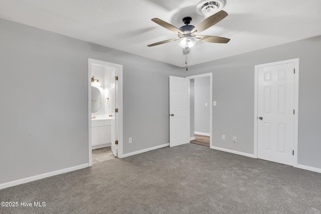 411 Cardinal Dr, Jacksonville, NC 28546 - unfurnished bedroom featuring carpet, ensuite bath, and a ceiling fan