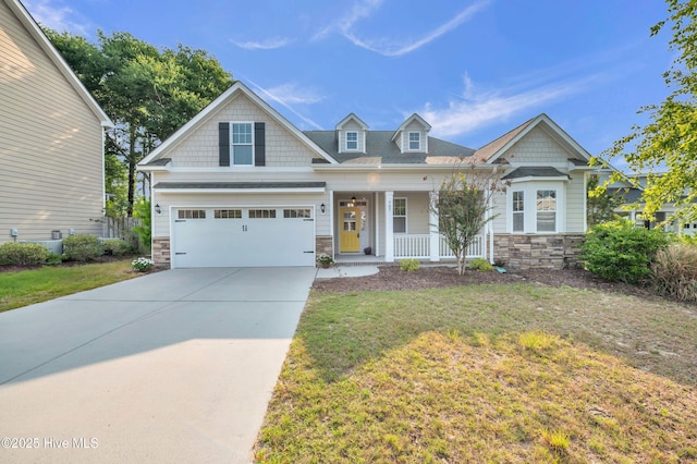 707 Liberty Landing Way, Wilmington, NC 28409 - craftsman house featuring stone siding, a porch, concrete driveway, and a front yard