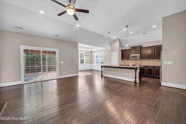 707 Liberty Landing Way, Wilmington, NC 28409 - unfurnished living room with a ceiling fan, lofted ceiling, healthy amount of natural light, dark wood-type flooring, and recessed lighting
