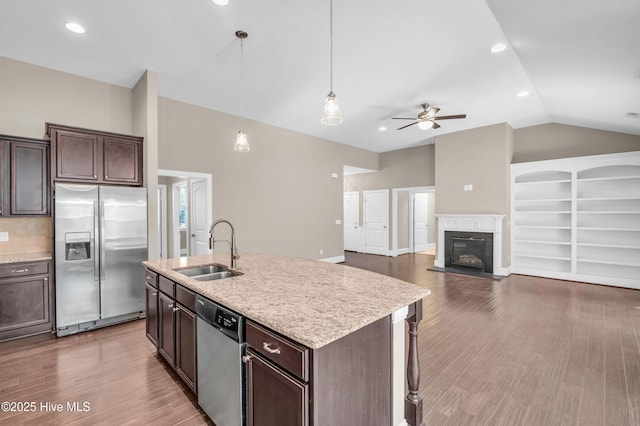 707 Liberty Landing Way, Wilmington, NC 28409 - kitchen with stainless steel appliances, vaulted ceiling, a ceiling fan, dark brown cabinetry, and dark wood finished floors