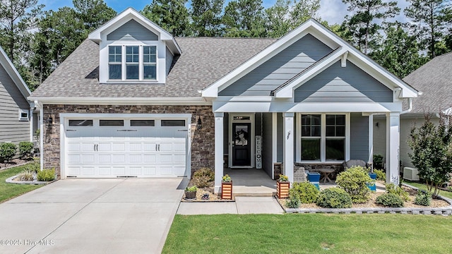 440 Bramble Ln, Clayton, NC 27527 - view of front of property with driveway, a porch, stone siding, and a front yard