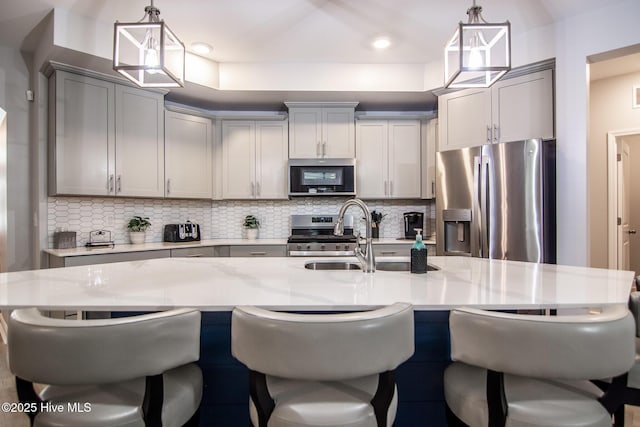 440 Bramble Ln, Clayton, NC 27527 - kitchen featuring stainless steel appliances, gray cabinets, decorative backsplash, a breakfast bar, and recessed lighting
