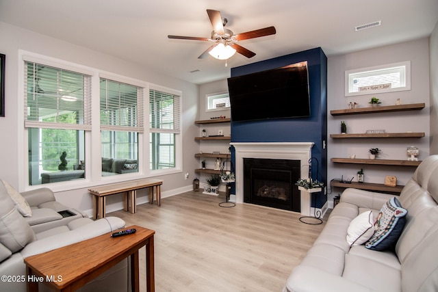 440 Bramble Ln, Clayton, NC 27527 - living area with a ceiling fan, wood finished floors, a fireplace, and plenty of natural light