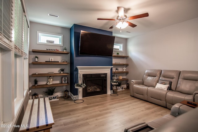 440 Bramble Ln, Clayton, NC 27527 - living room with ceiling fan, wood finished floors, and a glass covered fireplace