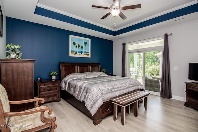 440 Bramble Ln, Clayton, NC 27527 - bedroom featuring light wood-style flooring, access to exterior, ornamental molding, a ceiling fan, and a raised ceiling