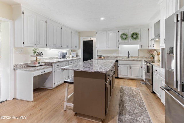 84 White Pine Rd, Lake Waccamaw, NC 28450 - kitchen featuring stainless steel appliances, white cabinetry, light wood finished floors, recessed lighting, and light stone countertops